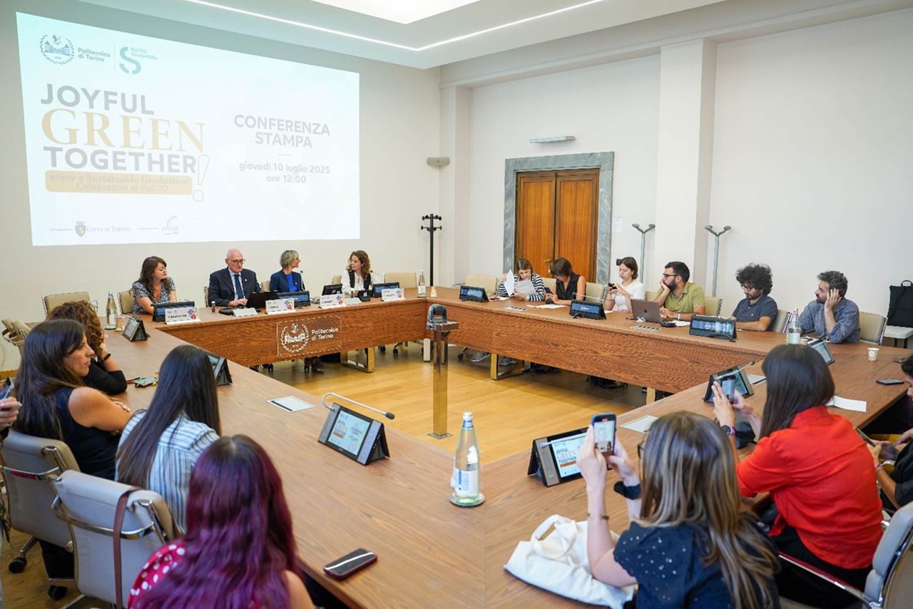 Conferenza stampa al Politecnico di Torino per presentare l’iniziativa "Joyful Green Together", con relatori seduti al tavolo e pubblico in sala.