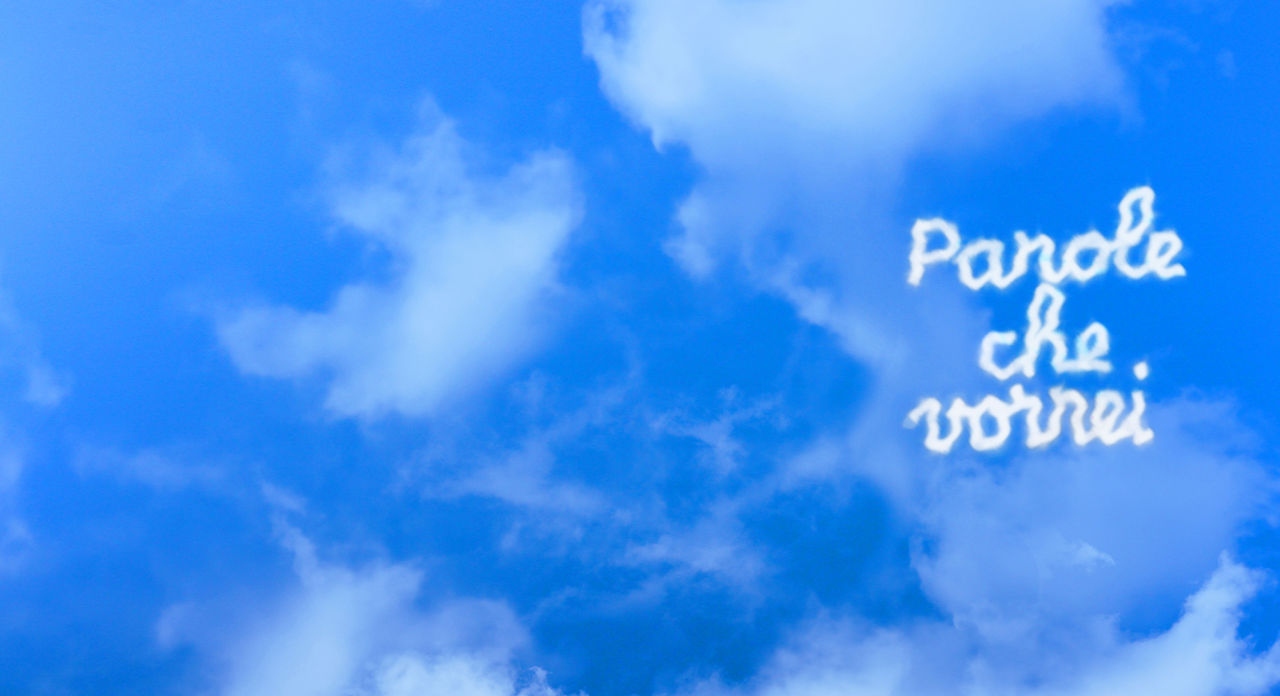 cielo azzurro con delle nuvole bianche che sul lato destro si addensano a formare la frase "parole che vorrei"